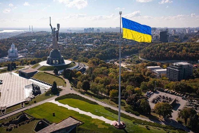 2057020673 Large Ukraine flag with cityscape in background.