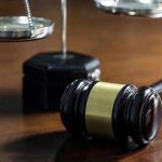 Street Preacher STUNS Supreme Court Gavel and scales of justice on wooden table.