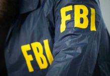 Madman Hurls Bones Over FBI Fence FBI jacket with yellow letters.
