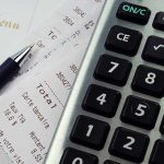 Pension HALTED After Illness – System EXPOSED Calculator, pen, and restaurant receipts on a table