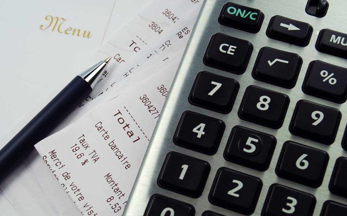 Calculator, pen, and restaurant receipts on a table