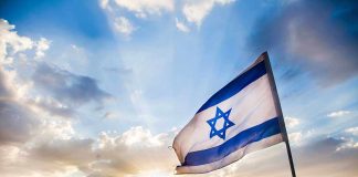 Israeli Forces SEIZE Syrian Town—Total Media Blackout Israeli flag waving against a sunset backdrop with clouds