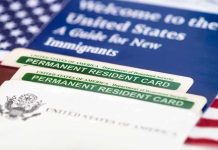 A guide for new immigrants alongside permanent resident cards and an American flag