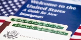 A guide for new immigrants alongside permanent resident cards and an American flag