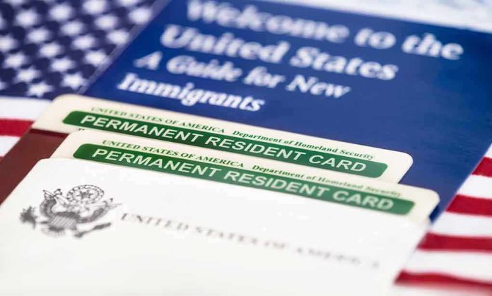 A guide for new immigrants alongside permanent resident cards and an American flag