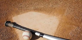 Baseball’s New Tech Fails: Manager Ejected A baseball bat and ball resting on a baseball diamond