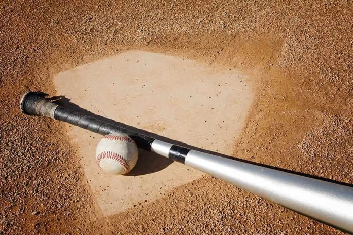 shutterstock_28231585.jpg A baseball bat and ball resting on a baseball diamond