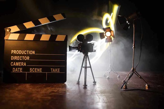 Film set with clapperboard, camera, and lighting.