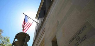 American flag at Department of Justice building exterior.