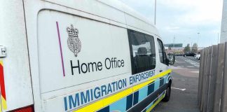 White immigration enforcement van parked by roadside