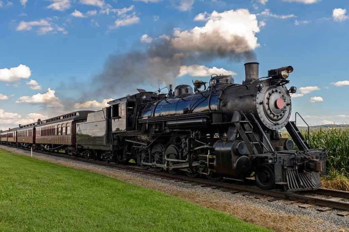 A vintage steam locomotive pulling passenger cars on a railway track