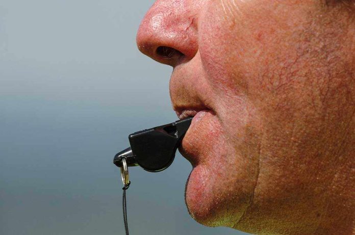 Close-up of a sports coach blowing a whistle