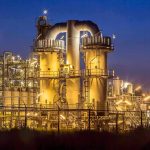 An industrial facility with illuminated structures at night