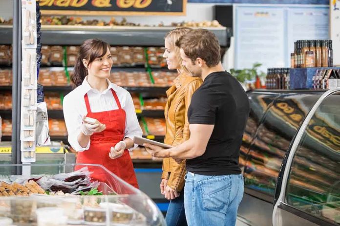 shutterstock_167509160 A grocery store employee assisting a couple with their shopping