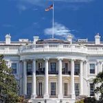 Hidden Camera CATCHES White House Staffer Red Handed! The White House with the American flag flying against a blue sky