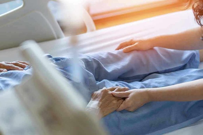 Hospital patient holding visitors hand reassuringly.
