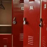 Hidden Armories Found On Campuses Red lockers with padlocks, one open with hanger.