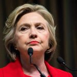 Hillary Clinton behind microphones.