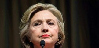 FBI File Targets Clinton’s Late Brother Hillary Clinton behind microphones.