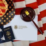 Trump Uses Unknown Law for the First Time Ever U.S. passport, gavel, and USCIS document on American flag