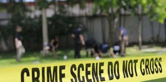 crime scene tape cordoning off a grassy area