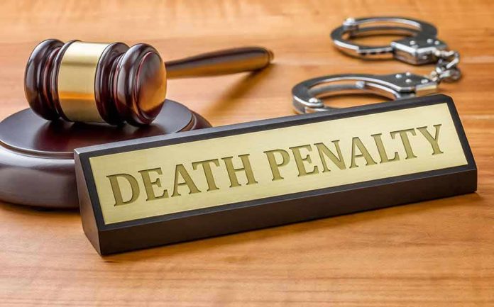 shutterstock_346370309 Gavel, handcuffs, and a nameplate reading death penalty on a wooden desk