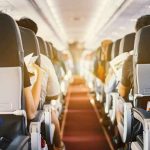 Airline Considers Adult Only Flights Airplane cabin aisle with passengers seated