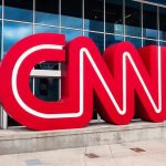 CNN Scrambles After EMBARRASSING Obituary Mix-Up CNN red logo sculpture outside a modern glass building