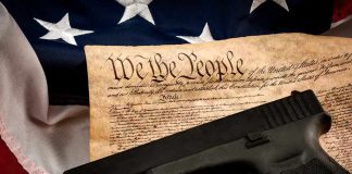 Judge Torpedoes 92-Year Gun Law – Trump APPROVES Handgun on U.S. Constitution with American flag backdrop