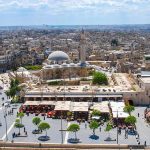 Tensions Explode After State Approves Massive Islamic Center Expansion historic mosque with domes and minaret overlooking a busy city square