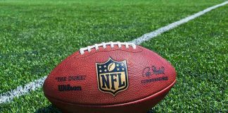 NFL Team To Return To Former Name American football on a turf field near a white yard line