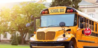 Yellow school bus with stop sign extended