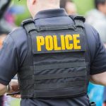 Police GUN DOWN College Star After Fatal Mistake Police officer wearing a tactical vest in a crowd