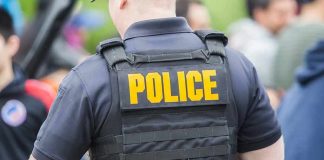 Police GUN DOWN College Star After Fatal Mistake Police officer wearing a tactical vest in a crowd