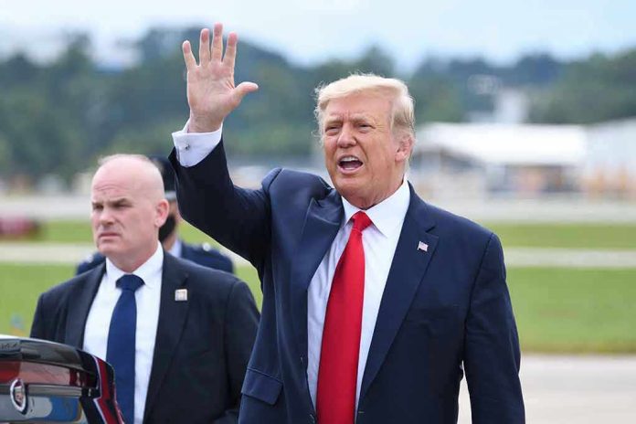 1821865589 Donald Trump waves while walking outdoors with security nearby
