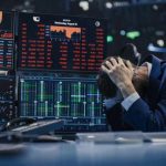 Trader stressed out by multiple declining stock charts.