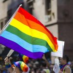 Dem Senator Viciously Booed at Pride Parade Kim Kyung-tae with others waving a rainbow pride flag at a street parade