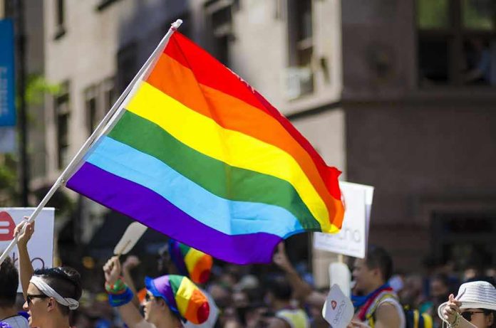 Kim Kyung-tae with others waving a rainbow pride flag at a street parade