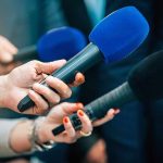 Shocking DIVORCE: Country Star Ends Decade-Long Marriage! Reporters holding colorful microphones