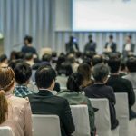 Bill Kenney at a conference panel with an audience