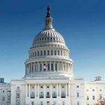 United States Capitol building with dome under clear blue sky