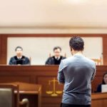 Courthouse Chaos: Defendant Slips Handcuffs, Taser Drops Him defendant stands before judges in a courtroom