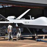 Iran’s Blitz Attack Targets U.S. Bases Military drone being serviced by ground crew outside a hangar