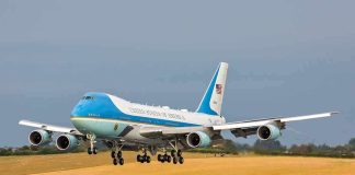 Airplane landing on runway with landing gear extended