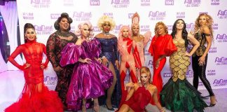 Group of drag performers posing on a red carpet