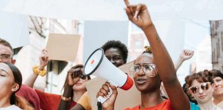 Protester with megaphone leading a crowd