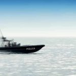 Police patrol boat speeding across open water