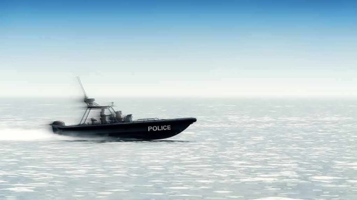 Police patrol boat speeding across open water