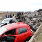 Overturned truck and damaged cars after highway crash