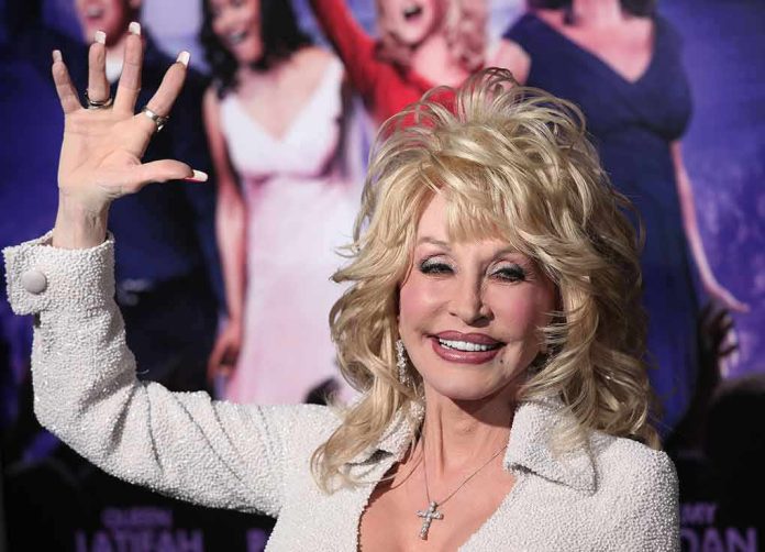 blonde woman waving at a red carpet event